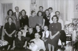 My grandparents, with grandpa's family in someones big living room, Christmas 1948. Back: Ida Brousseau, Francis Cowett, Kathleen Ouellette, Eileen Ouellette, Bernadine Ouellette, John Stumph, Antoinette Ouellette, Joseph Rohde. Middle: Mrs. Cowett, Aunt Genn (Marie-Zoe Trudell), Anne LeDuc, Marie Ouellette, Frederick Ouellette, Mary Zmuda, Norman Ouellette. Floor: Aunt Blanche (Marie Christine Trudell), Frank Zillich, Baby Fred Zillich. View full size.