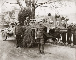 Easton Pennsylvania Armistice Day Parade Float.  A machine gun nest with a Hotchkiss machine gun and German war souviners hanging off the barbed wire posts. Scanned from the original 7.5x9.5 inch print. View full size.