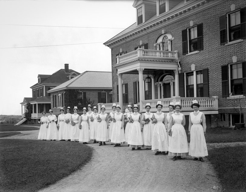 Newburyport, Massachusetts, circa 1904. A graduating class of nurses outside the main entrance to the Anna Jaques Hospital. 6½ x 8½ inch glass negative. View full size.
