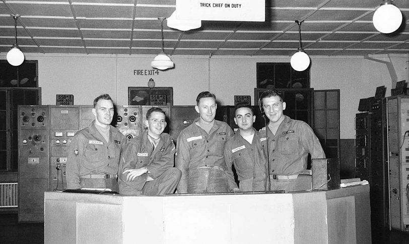 A small group consisting of myself and four army friends at the Camp Owada Receiver site near Tokyo, Japan. The photo was taken in 1956. Left to Right: Myself (Jim Carpenter), Hollis Killen, Marvin Tedder, Sam Panipinto and Leo Iten.
On this particular occasion, we were working the night shift.  When all was quiet with no work to do I put the camera on a tripod and used the self timer to take this picture. The camera was a 35mm Nikon S2 using plus X black and white film. Scanned from original 35mm negative.  
I kept in touch with Hollis Killen and Marvin Tedder over the years but they both are recently deceased.  Though I have tried, I have been unable to locate Sam Panipinto or Leo Iten since leaving Japan in 1957.
Such great friends as those I met during my tour of duty with the U.S. Army I’ll probably never meet again. View full size.
