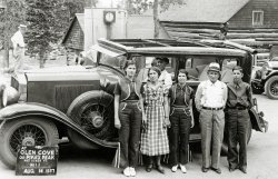 Taken near Pike's Peak, Colorado, my great grandfather's brother, George W. Downing, poses with his wife, family,  and one great automobile. View full size.
No ApostropheIn 1891, the US Board on Geographic Names recommended against the use of apostrophes, and in 1978 the Colorado state legislature passed a law requiring the use of Pikes Peak. However there are still 5 places in the States with apostrophes in their name.
[Zebulon Pike would probably have something to say about that. - Dave]
Nice hood ornamentWhat a great idea to make the car's hood ornament in the shape of a man with a straw hat!
Faded LuxuryA well worn 1929 Cadillac and a circa 1925 Pierce Arrow, at the rear
High Noonremarked Captain Obvious.
Roll-back RoofI've never seen a car roof like that: it's obvious that it can be rolled back, or closed using the prongs around its periphery, but is that factory standard or custom?
[This appears to be a tourist service in operation, providing sightseeing tours in the old 7-9 passenger sedan as well as a souvenir photo. As we've seen recently, solid metal car roofs hadn't arrived yet, but to me this adaptation has a rather do-it-yourself look to it. -tterrace]
Cars on Pikes PeakI remember being driven up Pikes Peak in 1960 in a 1953 Cadillac fitted with a specially fitted low-geared 3-speed transmission.  We ground up to the top because my mother did not want to drive our 1956 Pontiac, loaded with me, my two sisters, my aunt, and my cousin, up there.  I remember some concern as to the cost, but I (at 12) thought the Cadillac option was really neat.
Pierce-Arrows at AltitudeFor many years, the Broadmoor Hotel in Colorado Springs maintained a fleet of Pierce-Arrows (first modified limousines, then buses) for just such touristic service.  Those were later replaced by a number of stretch Cadillacs, some with Plexiglas roofs.
Having driven the route a number of times, I must say that the dirt portions could be challenging, and when most of the route was unpaved, such buses and limos must have seemed an attractive alternative to the private car to drivers from the flatlands ... and to their potential passengers as well.
1928 Faded LuxuryThe Cadillac is actually a 1928 model.  The parking lights mounted on the cowl are the primary detail that instantly differentiates it from the following year.  In 1929 these lights were scaled-down and moved to the top of the front fenders.
The Cadillac shown looks like the Custom Fleetwood Imperial for Five Passengers.  The molding above the windows that ends abruptly just after the rearmost window is not seen on the regular Five-Passenger Imperial.  The Custom Fleetwood version was more luxuriously appointed including satin-inlaid hardware which was two-tone gold with bright edging.  There were two occasional seats in the rear compartment.  The Custom Fleetwood cost $4,245 while the Five-Passenger Imperial was $50 less.
Cadillac offered more than 50 body styles in 1928 along with over 500 color combinations.  The marque's luxury image was enhanced by eliminating both the 132 and 138 inch wheelbases and standardizing on one of 140 inches.  The V-8 engine was tweaked, and it now produced 90 horsepower (up from 87).  Cadillac manufactured 56,038 automobiles in 1928 - including 16,038 LaSalles.  It would be their best year of production until 1941. 
Outfits?What are those matching outfits with the flared legs? They look like a cross between a cowboy costume and a basketball warm-up suit.
[Here's some women's casual wear of the 1930s. -tterrace]
Maybe a &quot;cool down&quot; location for the Cadillac I lived in Colorado Springs for 5 years and drove up the peak annually.  Being that the picture was taken at just over 11,000' they have already climbed roughly 4,000' from Manitou Springs, and they have another 3,000' to go to reach the summit.
I note that the engine cowling is raised and I suspect this was probably a planned stop to aid in keeping the engine cool on the way up.
As an aside, I found the trip up to the summit of Mount Evans near Idaho Springs a more exciting climb!  It is advertised as the highest paved road in North America.
The road was built to directly compete with Pikes Peak for tourist dollars.  It is not an accident that the parking area of Mt Evans is 20' higher than the Pikes Peak Summit.  The peak summits are within 150' in height of each other, but Mt Evans is slightly taller. 
"At the turn of the last century, Colorado Springs and Denver were in a race for the hearts and minds (not to mention dollars) of the eastern tourist. In 1888, the Cascade and Pikes Peak Toll Road Company completed a 16-mile road up the north side of Pikes Peak. This became a major tourist attraction, drawing tourists away from Denver Area. Not to be outdone, Denver's Mayor Peer proposed that a road be constructed to the top of Mount Evans. In 1917, he procured state funds to build the road. It was completed in 1927."
(ShorpyBlog, Member Gallery)