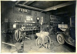 After careful study, I noticed that the clock on the wall has a hand for the day of the month. There is also a calendar on the wall set to April, but the year is unreadable. With a little bit of deducing, I was able to determine that this picture was taken on April 27, 1927 at 2pm (or 2am). It is also possible that the calender is old and the clock isn't running but I like my theory better. View full size.