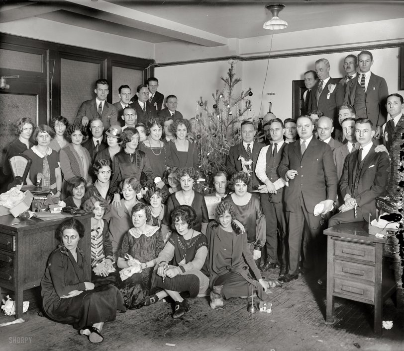 &nbsp; &nbsp; &nbsp; &nbsp; It's two Fridays before Christmas, time for a hallowed holiday tradition here at Shorpy: The Office Xmas Party! Which has been going on for 98 years now. Will Clarence in Sales ever get up the nerve to ask out Hermione from Accounting? Is there gin in that oilcan? Ask the bear.
December 1925. "Washington, D.C. -- Western Electric Co. group." There are enough little dramas playing out here to keep the forensic partyologists busy until Groundhog Day. National Photo Company Collection glass negative. View full size.