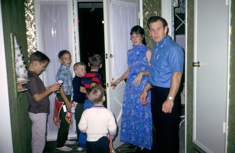 Christmas on the Left Coast, about 1968. We had moved from West Covina to Walnut. For a few years our family was friendly with a few neighbors. It didn't last. I think it was the times, and changing circumstances. I have good memories of them; here are the parents with their kids and my little brother going out the door. They were especially nice to me; I was about 12 or 13 at the time and they felt I was OK to sit for their kids. I made a dollar or two on those nights! I suspect my dad was again the cameraman. View full size.
