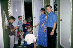 Christmas on the Left Coast, about 1968. We had moved from West Covina to Walnut. For a few years our family was friendly with a few neighbors. It didn't last. I think it was the times, and changing circumstances. I have good memories of them; here are the parents with their kids and my little brother going out the door. They were especially nice to me; I was about 12 or 13 at the time and they felt I was OK to sit for their kids. I made a dollar or two on those nights! I suspect my dad was again the cameraman. View full size.
(ShorpyBlog, Member Gallery)