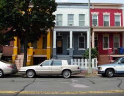 Houses in 400 Block of F Street N.E., photographed in 2008.  These same houses (#412, #414, & #416) appear in the 1921 Photograph of a Whistle Beverage delivery truck.  The location is directly across the street from the former site of the Whistle Bottling Works.  The bottling plant is long gone, but the houses remain.  Other then paint and replaced porch columns, little on the houses has changed.  #416 even has a flower pot along the right side of the steps in the same place.