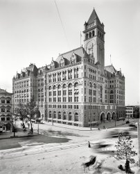 Washington, D.C., circa 1900. "U.S. Post Office, Pennsylvania Avenue." The Old Post Office back when it was new. 8x10 inch glass negative. View full size.
*#!!#*!!  TurretsYou're not #!#*! alone tterace. I think there'a a lot of
*#!!##* people who would like to enjoy some ##!!*! time working or relaxing in a !!*#! turret room!
Turrets syndromeAm I the only one who has this strange yearning to live or work in a turret?
Gargoyles, pleaseWe need a few gargoyles to go with those turrets. The spires on the roofs are too plain for all that decorative fenestration.
Surely the spirits of all those broiled alive lobsters in the foreground building, could be channeled into appropriate energies to produce the gargoyles.
As for the foreground building, it appears to be beautiful, from what I can see of it. Any chance it survived the wrecking ball? (I kinda doubt it, but I can hope).
If this is a poll:I’m  a turreteer too!
An old mill with a working wheel would do too. (wind or water)
What was in those turretsI've always been curious as to what kind of space it was inside those small turrets. Offices? Sitting areas? Would be cool to see an inside shot looking out.
Turrets are coolI agree with tterrace that they would make an interesting work or living space, but they sure are a tough place to hang pictures!
Harvey&#039;s RestaurantLower left corner, Harvey's was one of the top restaurants in DC and hosted most notable politicians, entertainers and business leaders in its day.  My mother was taken there (not the same location) on a date when she was stationed at Andrews Air Force Base in the early 1950s.  Here is a link to some of the history.
Former home of the FBIBefore the FBI moved to its own building, it maintained offices in the Old Post Office. My late father was a special agent at the Washington Field Office for 25 years and worked out of this building. A couple times a year my mother would drive my brother and me into Washington to pick him up. We parked in an inner courtyard and we kids watched for my dad to come out of that confection of a building. All the agents wore dark suits, trenchcoats, white shirts, ties and fedoras. Then we would drive up to the DuPont Circle area to our favorite restaurant, Pouget's, for drinks and dinner (Shirley Temples for my brother and me). That was long ago.
Still more turrets out here in palm tree landSeveral San Diego neighbors have a turret rooms in their 1920s Spanish Colonial houses facing Balboa Park. They all use them for displaying their Christmas trees for passers-by to enjoy; sadly, the rest of the year they mostly stand unused.
Dark Shadows at the POThis ca. 1908 color litho postal card of the Old Post Office at night lends the building a forbidding Gothic  spookiness that fades in the daylight. Cue the Bach organ Toccata! Release the bats!
SanctuaryIf you are in fear for your life, head for the turret. They can't corner you there.
The HunchbackI think it's obvious the turret must have been occupied by the hunchback who rang the tower bells.  It was sleeping in that small space which permanently curved his back.
Inspirationfor Disney buildings to come perhaps. Dave, any chance that seafood place on the left is called Harvey's?
[Harvey's Oyster House. - Dave]
Old P.O. TowerA  couple years back, during some sort of food fair on Pennsylvania Avenue, we were lucky enough to go to the top of the tower. Half my brain was damning the waste of public money and the other half was saying, "Wow! What a great view!"
Room at the topThe real treat in this building is the top of the bell tower. There is a bell chamber complete with bells, about where the clocks are, and above that is a viewing space (the three arched openings on each side) with great views of the DC area. Easy to access and usually not as many standing in line since everyone goes to the Washington Monument. The thankfully never-to-be-completed Federal Triangle complex is on the back and nearside of this building; the 3 and 4 storey buildings are long gone.
Room With a ViewIf you visit DC, it is well worth the trip to see the inside of the Old Post Office as well.  The tower still affords a great view of Washington and the surrounding area.  Of course, one of the great benefits of DC is that so much one can do there is free of charge.
A New SensationThis building has undergone a major transformation in recent years. Inside is a food court with diverse offerings, and a shopping mall.  There are tours given up to the clock tower which is either the second or third highest elevation in the city, after the Washington Monument, of course. I think there may be some nightlife available here, too.  Glad they saved this historic building.  I hope this becomes a trend.
21st Century TurretToday, the turret of the Old Post Office is used as a microwave relay site by many of the network and local broadcasters in the Washington area.  Boasting a good line of sight from much of the downtown DC area, they can point their live truck antennas at the tower, where the signals are relayed (via fiber optics) to their studios around town.
It&#039;s Still ThereAnd a nice place to visit.  Right in the middle of the downtown tourist area.  Open to the public, the central atrium now has shops and eateries.  The last time I was there, I rode the elevator to the top of the tower where you could look down on "The Avenue" from those arched openings.  I hope that is still available.
Ours was saved!A similar Federal Building in Saint Paul was saved.  It is now the Landmark Center and is where I work!
(The Gallery, D.C., DPC)