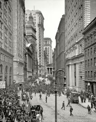 New York circa 1905. "Broad Street exchange and curb brokers." 8x10 inch dry plate glass negative, Detroit Publishing Company. View full size.
No barsHow did they ever get any business done? All of these businessmen, and not one using his cell phone!
What did she forget to tell him?Love the lady leaning out of the third floor window on the lower right to say something to the man who appears next to the lamppost, looking back up at her.
Hey JoeYou can meet my brother tomorrow afternoon on Broad Street. He'll be the one wearing the bowler.
No AutosIt's interesting that there don't appear to be any motorized vehicles in the picture.  So far as I can see, everything is horse-drawn.
It appears to me that nearly all of the businessmen in the picture are wearing bowlers.  For the most part, other hats, such as caps, are on younger men.  Thus, I am guessing that the woman leaning out the window has sent the young man as a runner on some errand, and perhaps is, as coriander suggestions, adding something to the request.

The American Stock ExchangeThe "curbstone market" was the predecessor of the American Stock Exchange.
PeekingI love to see if anyone is looking out those windows ... Found one!
Lux MortemAwesome example of a Bishop's Crook Type #1 with crossbar. Today's reproductions are based on the BC type 24a, which look pretty close. But those globe luminaires hanging from the fluted fixtures are long, long gone.
What are we all looking at?It seems like there is a LOT of folks in the middle of the street doing something -- but what?
[Trading stocks. - Dave]
Au courantHere's the 1905 look, complete with a bowler hat..
And this is:Where I have all my money invested? Wish I would have seen this photo before my chat with an investment dealer.
Get that man a hat!I see you there to the left of the foreground globe...  You think you can just stroll about in public half naked?  
There's always one in the crowd!
One Hatless MaleAnd two women. Love the pic.
Neither Rain nor SnowGreat Photo! Does anyone know what the denizens of the Curb did when the weather got nasty, similar to what New York experienced this January?
Post Lux MortemThe crossbar is an artifact from the gaslight days, where the lamplighter would rest his ladder.
StandoutThere's one top hat (left foreground) vs 1,000 bowlers. Is this an executive? Mr. Peanut?
Nothing much changed by 1980I worked at 48 Wall Street for 16 years. Wall Street intersects at those steps at the top of the picture. That is where George Washington once spoke. Really, very little had changed. Most of those buildings were still there, and the crowd levels were the same. By 1975 crowds weren't playing stocks but 3 card monte that would scram when the lookout whistled. 
Until about 1980 men with bowlers and tophats still walked the streets. They were carrying physical stocks and bonds between dealers. There was a 4 pm drop dead delivery for all transactions.
Hats off to youI'm reminded of the Simpsons episode where Homer ends up in the psych ward after wearing a pink shirt to the plant. The guys in lab coats were probably headed right for the poor hatless gentleman right behind the lamp bulb when this picture was taken.
Strange that a century later those wearing hats on a regular basis are the odd ones.
What are the vendors selling??I see apples and, what exactly?  Parsnips?  Carrots?
Topless on BroadPerhaps the crowd gathered are actually trading. Or maybe, when the man without a hat showed up, they all ran ran away from him, as if he were some strange alien, and are all discussing what they are going to do about this social deviant. Notice he's all alone there in the middle. Perhaps the man walking toward him (with something in his left arm...maybe a summons) will be the one to set him straight. "Sir, you need to put a hat on, or else. Get with the system, man."
A tale of two citizensA few paces behind the gent in the top hat is a fellow in working garb -- a lighter colored jacket that is open, with a different style hat. 
And on the other side of the street, there is a fellow who is sitting on the railing, getting his shoes shined.
Three left standingActually only three of the buildings shown here are still standing: 1) The New York Stock Exchange of George B. Post (the pedimented building midway up the left side of the street), built in 1903; 2) the Subtreasury, aka Federal Hall National Memorial, originally the US Custom House (the partially visible Greek temple at the corner of Wall Street), built by Town and Davis, 1833-1842; and 3) the Broad Exchange Building, second from the right, built by Clinton &amp; Russell in 1900. Everything else you see has been torn down and replaced by newer buildings.
[The poster below was speaking of the 1970s. - Dave]
You could hear a pin dropI worked on the Staten Island Ferry on weekends in the early 70's.  The whole area was a ghost town when business was not in session.  I remember the sound of a windblown rope hitting a flagpole that you could hear from blocks away.
The Third LevelSo few women, it looks like the Egyptian demonstrations. Only 100 and a few years ago, some of our grandparents just kids then, but the cityscape is overwhelmingly male (except for a few women selling fruits and vegetables from the carts). Are the men actually purchasing vegetables to bring home for supper? There's one man in the foreground on the left smoking a cigarette, while the man next to him has his hand up to his face like he is using a cellphone. Or making a gesture of some kind ("Hey, can you spare a smoke?") Of course, this could be a Jack Finney time traveler who forgot he isn't supposed to bring his cellphone and that not only do cellphones not work on planes, they don't work when you take the Third Level either.
Fruit CartsIf you're wondering what those carts are all about, they are selling fruit, not vegetables, to the brokers, who often didn't have time for a proper lunch. Instead, they'd grab a couple of apples or bananas, etc., and go back inside for more trading.
(This comment from food historian Jane Ziegelman)
ToucheI wonder what put a smile on the faces of the two men at bottom left, who btw look very much alike. Brothers? The bear of a man in centre front of the milling throng seems to be looking at the photographer.
SlapstickI got to thinking about all those discarded banana skins that seem to be in the gutters, on the road and doubtless on the footpath (sidewalk) in this photo. And wondered if this was a common sight in other locations where the fruit vendors plied their trade. Is this then the basis for the comical slipping on a banana skin routine? (BOBS).
A person slipping on a banana peel has been a staple of physical comedy for generations. A 1910 comedy recording features a popular character of the time, "Uncle Josh", claiming to describe his own such incident:
Now I don't think much of the man that throws a banana peelin' on the sidewalk, and I don't think much of the banana peel that throws a man on the sidewalk neither ... my foot hit the bananer peelin' and I went up in the air, and I come down ker-plunk, jist as I was pickin' myself up a little boy come runnin' across the street ... he says, "Oh mister, won't you please do that agin? My little brother didn't see you do it."(wikipedia)
Top 5This is truly a great picture but curious what makes it so popular that it has virtually become a permanent photo in the top 5? The last posted comment was on 2-19. Thanks for any info.
[Links from Stumbleupon and Reddit. - Dave]
Thought I would shareCute little moment they happened to catch.
Old Stomping GroundI love this 1905 photo and miss working at 25 Broad St (Paine Webber). I get a kick out of all the banana peels! Guess Peter Coyote is correct, it's a perfect food.
(The Gallery, DPC, NYC)