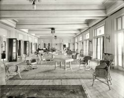 Bluff Point, New York, circa 1910. "Hotel Champlain, ladies' parlor." Continuing our tour of upstate New York resorts. 8x10 glass negative. View full size.
I&#039;m always amusedwhen verbosity masquerades as intellect.
[Speaking of which, there are two things that may have slipped your notice. - Dave]
CoolDig those wicker rockers.
Haunting imageI see a ghostly male duo at the far end. They seem to be sorting mail or something of that ilk. 
I can imagine a lady in one of those period dresses seated at the piano, accompanied by a violin and a flute, or maybe a singer with a lovely soprano voice. 
(The Gallery, DPC)