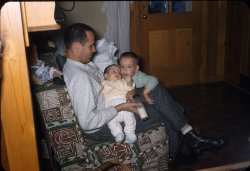 Another 35mm slide from the farm, 1956. Raggedy Ann is seated on the back of the settee. Dad has just fed George and I am about to dose off. View full size.
(ShorpyBlog, Member Gallery, Kids)