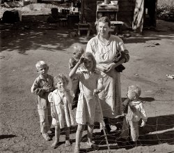 August 1939. Yakima Valley, Washington. Shacktown community, mostly families from Kansas and Missouri. This family has five children, oldest in third grade. Rent $7 per month, no plumbing. Husband earns Work Projects Administration wages, $44 per month. View full size. Photograph by Dorothea Lange.
An interesting comparisonThat figure of $44 per month, according to the Bureau of Labor Statistics Inflation calculator ... converts to just over $152 per week in 2007 dollars.
This calculator is a nifty little tool
http://data.bls.gov/cgi-bin/cpicalc.pl
Dale
(The Gallery, Dorothea Lange, Great Depression, Kids)