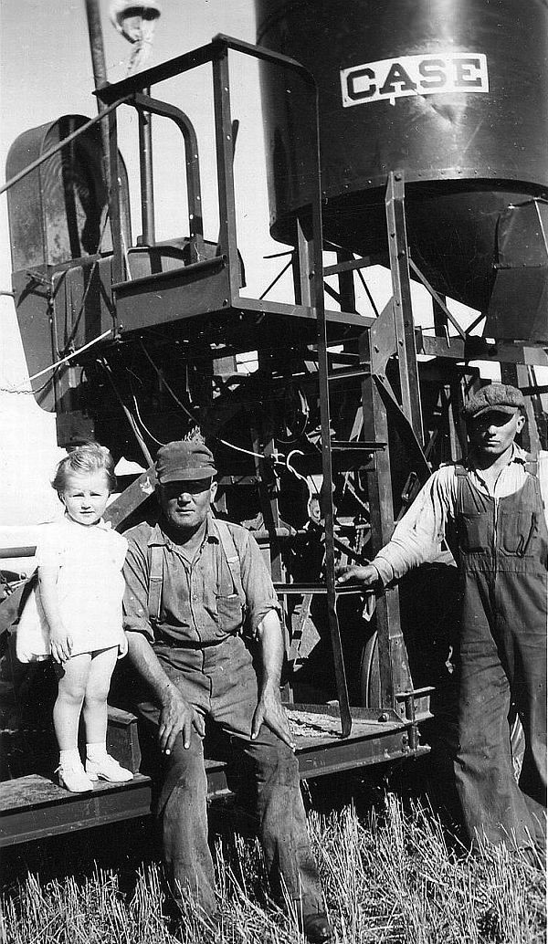 Taken in Saskatchewan,in the Fall of 1946 or '47, near the Cowessess First Nation. My sister Eileen, my Dad, Kenneth C. Johnston, and his helper, Joe Fuchs.  The combine would have been almost new. View full size.
