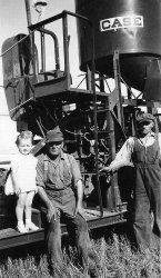 Taken in Saskatchewan,in the Fall of 1946 or '47, near the Cowessess First Nation. My sister Eileen, my Dad, Kenneth C. Johnston, and his helper, Joe Fuchs.  The combine would have been almost new. View full size.