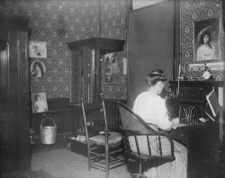 Central New York State.  Does anybody know if this would have been the telephone system for a hotel or possibly for an entire small town?  The poster with the girl standing on a swing is for the New York State Fair but there’s no year on it.   Scanned from the original 5x4 inch glass negative. View full size.
Hello operatorTwo kinds of switchboards here. The one in back looks especially antique.
(ShorpyBlog, Member Gallery)