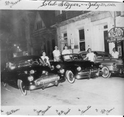 Frankie's friends with their cars in front of the Club Slipper on Bourbon Street, July 29, 1948.  Names of his friends were already on the photograph. He was my first cousin but quite a few years older, I did not know his friends then. This picture is in my possession. View full size.