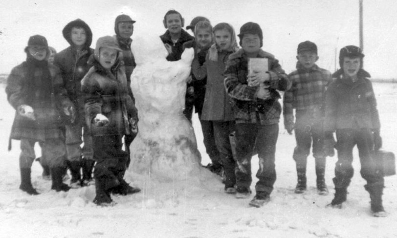 My father and two brothers attended the Dayton Township school near Canton, South Dakota, and this photo captures the accomplishments of some of the boys who attended that school.  Dad guesses this photo to be in the winter of 1952-53.  Although my father is strangely absent from this photo, his two brothers stand in the back row on either side of the snowman. View full size.
