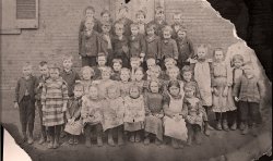 My Grandfather and his first grade class in front of an unidentified grade school building in Gallipolis, Ohio.  I'd love help identifying it exactly if it still exists. View full size.