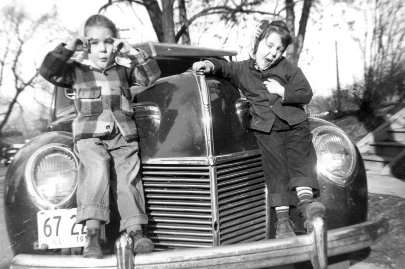 Photo taken on Washington St. in Freeport IL circa 1950. Why do pretty girls like to sit on car fenders? View full size.
