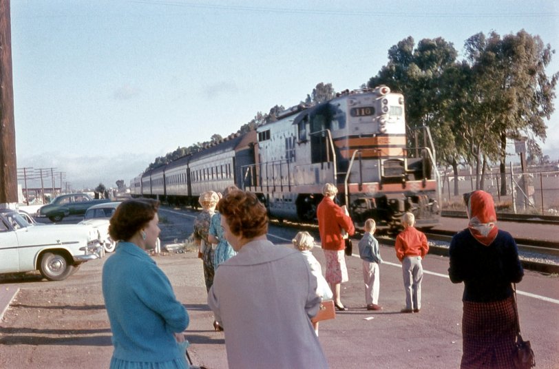 My mother, brother, and I are waiting as the Southern Pacific passenger train pulls into what was then the Hillsdale Station, just outside of San Mateo, CA. (It's now a Caltrain station.)
My father worked in San Francisco at the time and used to take the commuter train to and from work. I started to write that we were probably picking him up at the station, but he's the one that snapped the picture! Taken on Anscochrome film, August 1959. View full size.
