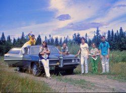 Photo of my family taken near Quebec City in 1968.
Hippies influence. View full size.
re: Flowers/HairI love this shot! Thanks. I fiddled around with the colors and came up with this:
I can dig it!Yeah, that would have been the equivalent to me, the fellow on the right. Neck scarf worn proudly.
Seemed like a good idea at the time. Slaves to fashion.
Two Tone BlueA lovely Pontiac, cute kids and and awesome sky!  What more could one want?
(ShorpyBlog, Member Gallery)