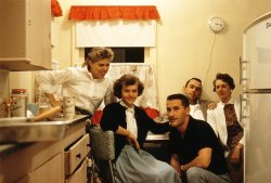 January 1959. In this prequel gathering of the California Picnic group here, we have Ruby Lee and her hubby (back right), their daughter Peggy (def. too young to drink) cozying up to declared hottie Clay (who is not Thomas Cave a.k.a Mr. 535-07-5248) as his wife gamely looks on. Part of the Humphries Family Kodachrome collection. View full size.
Perhaps January 1st?It's 3:15 and it's dark outside so this is the wee hours of the night, either it's New Years or these are hard core party people. 
The kitchen is classic! the colors, the appliances, the clock, very nostalgic.
[The clock says 9:15. - Dave]
So it does, the hour hand was blotted out by the flash. "Never mind"
[Actually, this was taken by available light, not flash. -tterrace]
Familiar FurnitureI see a wonderful old kitchen table peeking out there.  I remember we had a table like that with the aluminum (?) sides and the great chairs that matched.  Great photo.
So what&#039;s the brand?Not one but two cans of beer visible, and I can't quite make out the brand name.  It appears to be Buck[something].  Two brands around in 1959 that would have started with Buck were Buckhorn, produced by Olympia Breweries in Texas, and Buckeye, an independent brand from (duh!) Ohio.  Neither one's logo was similar to that in the picture and it's doubtful that either would have been distributed in California.
Grandmother&#039;s Kitchen TableMy grandmother had that same table-and-chairs set, with the same pattern cushion covers, in her kitchen as well. Wedged into about the same amount of space!!
(ShorpyBlog, Member Gallery)