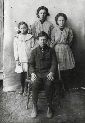 This photo was in a group of photographs I purchased at a flea market. The photos that were dated were over a hundred years so I would guess this was taken around the turn of the century. This one had "Mrs Dillie Taylor, Okla" written on the reverse. I find the photograph amusing because the kids look genuinely annoyed at having to sit for the camera. View full size.
(ShorpyBlog, Member Gallery)