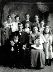 Charles and Phoebe Nord and ten of their children in Balaton, Minnesota, about 1914.  My great-grandmother Florence is standing, second from left (with the white ribbon in her hair).  Another boy was born three years later. View full size.