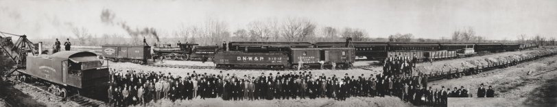 May 1908. Panoramic view shows well dressed men and women, and railroad employees, posed by locomotives, a steam shovel, tenders, boxcars, passenger coaches, flat cars and gondola cars at Utah Junction (near Pecos Street and Cargill Drive) in Adams County, Colorado. View full size.
