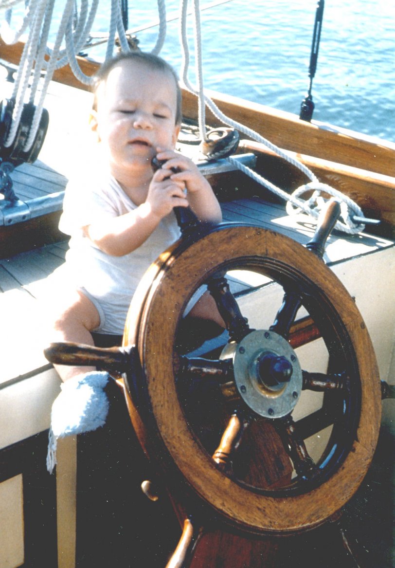 When my son was 9 months old in 1952, we took him aboard his grandfather's sailboat, Silhouette, on Chesapeake Bay, MD. This was his reaction when we sat him at the wheel. Guess he didn't have sailing on his mind at the time.
