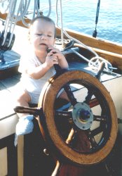 When my son was 9 months old in 1952, we took him aboard his grandfather's sailboat, Silhouette, on Chesapeake Bay, MD. This was his reaction when we sat him at the wheel. Guess he didn't have sailing on his mind at the time.
Snack food I guessI remember this photo from when we were little kids and recall not understanding why my brother would want to chew on a steering wheel. They don't taste that good - do they?
(ShorpyBlog, Member Gallery)