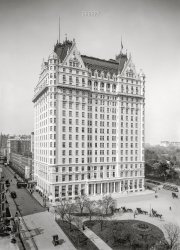 Manhattan circa 1907. "New York, N.Y. -- Plaza Hotel, Grand Army Plaza and W. 58th Street." 8x10 inch dry plate glass negative, Detroit Publishing Company. View full size.
You can still see that gategb, that wrought iron gate was one of two at the carriage entrance to the Cornelius Vanderbilt II mansion, formerly occupying the west side of Fifth Avenue between West 57th Street and West 58th Street, at Grand Army Plaza (seen in the 1907 photo).  The mansion was demolished in 1926.  One gate is now at the 105th Street entrance to Central Park.

Top HeavyIt always amazes me that so much of the architectural ornamentation on buildings is at the top.  Even to this day, walking around New York, or any major city, there's nothing to see at street level.  It's all at the top, which you can only appreciate if you can manage to get a perspective like this photo.  Would love to know what the elaborate gate in the lower left led to.
So Jim,Hansom cab line, center right: "So Jim, ya got those fancy new oversize wheels. How do you like 'em?"
Withering heights for meThey couldn't pay me enough money to be the flag raiser on that building.
Vanderbilt MansionThe elaborate gate on the left led to the front door of Cornelius Vanderbilt II's very large mansion. Cornelius II, oldest grandson of Commodore Vanderbilt (the first Cornelius), hired the architect George B. Post to design his house at the northwest corner of Fifth Avenue and 57th Street. The house was completed in 1882. In 1893, Cornelius II hired Post to expand the mansion to the north, covering the entire Fifth Avenue blockfront between 57th and 58th Streets. It was said to be the largest private house ever built in New York. The house was demolished in 1926 to make way for the Bergdorf-Goodman department store. CV II's other house was the gigantic "summer cottage" called The Breakers in Newport, Rhode Island.
Vanderbilt GatesThe Cornelius Vanderbilt II mansion at the corner of Fifth Avenue, 57th Street and Grand Army Plaza in 1908.

The Little House Across Way ...was a small home that belonged to the Cornelius Vanderbilt II family.  It was situated at the northwest corner of Fifth Avenue and West 57th Street, extending to 58th Street, directly across from the Plaza Hotel. This property is recognized as the largest private residence ever constructed in New York City. Maintaining the estate necessitated a staff of 37 servants. The house was completed in 1893 and subsequently demolished in 1926; the land was later sold for $7 million, and the original structure was replaced by a 12-story luxury cooperative building. Notable features of the estate, including the 10-foot tall iron gates, a baronial fireplace designed by Augustus Saint-Gaudens, a Moorish ceiling piece from the smoking room, and various other opulent elements, were donated to charitable organizations.  The former front gates of the mansion now reside at the 105th Street entrance to Central Park
https://en.wikipedia.org/wiki/Cornelius_Vanderbilt_II_House
https://www.untappedcities.com/then-now-the-cornelius-vanderbilt-ii-mans...
Early EV?Would love to be able to identify the horseless carriage at lower left.
[It's an electric taxi -- a sort of horseless hansom cab. - Dave]

Electric Hansom CabThanks Shorpy, you sent me down a rabbit hole with this little blurry thing. I see others are interested, here is the the best non watermarked photo I could find.
(The Gallery, DPC, NYC, Streetcars)