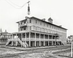 Circa 1907. "Hotel Sheldon, Wildwood, New Jersey." Streetlight photobomb. 8x10 inch dry plate glass negative, Detroit Publishing Company. View full size.
A parking lot, now.The house to the right in the back is still there, so... at least there's that! 
[Also the house to the left. -tterrace]

(The Gallery, DPC)