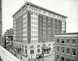 Utica, New York, circa 1910. "Hotel Utica." Playing next door at the Majestic: "The Fortune Hunter." 8x10 inch dry plate glass negative. View full size.
John Barrymore in town?John Barrymore starred in "The Fortune Hunter" in 1909-10. This from "The Home Front Encyclopedia". 
The Fortune HunterWas a 1909 play written by Winchell Smith 1871-1933, who also wrote a play based on the novel Brewster's Millions.
The Fortune Hunter was made into a film in 1914.
More on the Majestic Theatre here. http://www.oneidacountyhistory.org/Recreation/Recreation.asp
Click on Grand Old Theatres
OSHA Panics!!That fella hanging out the window on the left side of the building doesn't look like he's even wearing one of the belts used by early window washers.  Looks more like a kid told to scrub the window.  Scary.
[Look closer. There is some sort of chain or strap holding him in. - Dave]
Revised and RetouchedThis negative was used as the basis for a highly retouched print. Click to enlarge.

FestoonedWhat do we make of the small lights festooned around the top of the building?  Holidays?  
Really, I just wanted to use festooned in a sentence.  I'll show myself out...
Shiver running up my spineSo I grew up in Utica.  Moved away for 20 years, moved back 10 years ago.  I'm sitting in the lobby of the Hotel Utica with my laptop and this picture is posted on Shorpy.
(The Gallery, DPC)