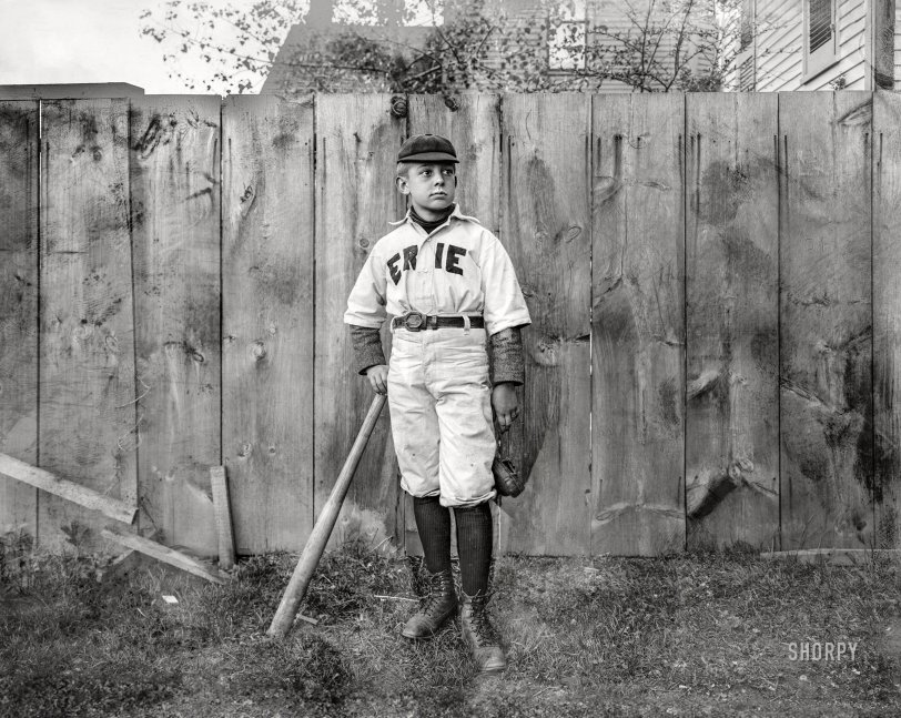 Circa 1900-1910. "No caption (boy in 'Erie' baseball uniform standing by fence)." 6½x8½ inch dry plate glass negative, Detroit Publishing Company. View full size.
