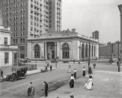 Detroit circa 1910. "People's State Bank, Fort and Shelby Streets." Designed by McKim, Mead &amp; White. 8x10 inch dry plate glass negative, Detroit Publishing Company. View full size.
Bank SavingOriginally the State Savings Bank, the building was almost torn down for parking by a Toronto developer in 2012. For once, the city denied the request.

Still thereI've been in the building a few times.  Bedrock uses it as an event center.  It's mostly just empty space inside except for the vault.
Women&#039;s Commercial DeptThe March 1905 edition of The Architectural Review called this building the Detroit State Savings Bank.  I don't know what the interior looks like now, but it was beautiful then, even with spittoons.  Here's the floorplan.  To the right, as you enter, is the board room and president's office.  And, to the left, with its own tellers, bathroom, fireplace, and vase of flowers, is the Women's Commercial Dept.  Interesting to know a demand created the need for this.
Street lifeLove the street life in the old photo.  Looking at today's photo everyone is in their car, not a pedestrian in sight!
More better viewsAre here.
(The Gallery, Bicycles, Cars, Trucks, Buses, Detroit Photos, DPC)