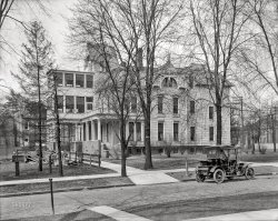&nbsp; &nbsp; &nbsp; &nbsp; UPDATE: This is the Boulevard Sanitarium, founded in 1903 at 251 West 25th Street. Hat tip to Shorpy member William Lafferty.
Detroit circa 1908. "No caption (automobile parked in front of three-story house with side porch)." At the construction site next door: "These lots for sale. Enquire W.S. Pocock." 8x10 inch dry plate glass negative, Detroit Publishing Company. View full size.
Boulevard Sanitarium ... at 829 West Grand Boulevard in Detroit, a former mansion turned into a private hospital.  It began in 1903 not far away at 251 West 25th Street and seems to have lasted until 1925 or so.
[Thank you for the brilliant detective work! Although I think this is at the 25th Street address. - Dave]


Dropped off the mother-in-lawTrying to identify the car.  Maybe a 1908 Maxwell Runabout. Looks like it has a mother-in-law seat in the rear -- away from the driver and passenger. No covered top and out in the wind.
Queen AnneLike the lovely Queen Anne style design. Wonder who built this as the original mansion. The interior alterations from home to hospital must have been interesting, along with the background of the staff.
I had to look it upBecause I was not sure of the difference between a sanitarium and a sanitorium. A brief search later, I had this explanation:
The definition of the words is often not clear; however, with a few exceptions, sanatoriums (with an 'or') served people with tuberculosis and sanitariums (with an 'ar') were for people with a variety of illnesses who needed to convalesce.
That being the case, my late maternal grandmother (1918-1981) was once consigned to a sanitorium for a short while, in Louisiana where she lived. My mother was old enough at the time to remember it. Only, Elizabeth, or Mamaw as I would later call her, did not have tuberculosis. She had been misdiagnosed. When the doctors discovered their mistake, they sent her home to resume her domestic duties and live out her life, which was eventually cut off by pancreatic cancer.
[Sanatorium, or sanitorium? - Dave]
Sleeping porchesThe large upstairs porches were often used as sleeping quarters for people with tuberculosis. It was thought that exposure to fresh air helped cure the patients, even in a Michigan winter.
I-75The interstate wiped out this neighborhood.
Survived a bit longerDetroit went through a street renumbering in 1921.  The address 250 25th Street became about 1101 25th Street.  Without spending too many hours looking up the existence of this place, I can say that it was definitely there in aerial photographs on 4/13/56.   And it was gone by 5/30/61.  By the looks of the ground and the lack of vegetation in the 1961 photo, I'd guess that the demolition happened in 1960 or 61. In the 1956 image, you can barely see that curved front walkway.
ThanksOnce again Shorpy-ites are clutch!
Thank you @JennyPennifer and @VIrginian for answering my questions before I even asked them! LOL.
(The Gallery, Cars, Trucks, Buses, Detroit Photos, DPC)