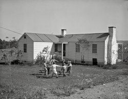 October 1934. "Children in front of their new home. Reedsville, West Virginia." Photo by Elmer Johnson for the Resettlement Administration. View full size.
Our second look at ArthurdaleOne of the first type of houses built in Arthurdale, WV, the first New Deal homestead project.  Nearly all of the original houses are still standing, and most remain in excellent condition.  
Like the SongLooks like what C,S,N,&amp;Y might have had in mind.
Inspiration?Similar to the very popular sculpture in Loveland, Colorado:
Stacked like hotcakesI'm the youngest of 9 and can remember when all but my oldest sister was at home; but I find it hard to imagine a house that small having enough bedroom space for 9 kids, unless they lined up bunk beds like army cots in every room.
(The Gallery, Kids)