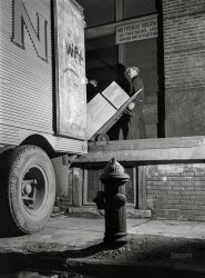 February 1943. "New York, New York. Associated Transport Company trucking terminal on Washington Street. Loading goods on a southbound transport." Medium format acetate negative by John Vachon for the Office of War Information. View full size.
Night MovesThe term Dave's title plays on was known in 1943 from railroads shifting rolling stock overnight. In the years since it has acquired considerable cultural presence, first as the title of a 1974 noir film starring Gene Hackman, whose character plays chess (with tricky 'knight moves').  In 1976 Bob Seger took it as the title of a song about adolescent love, saying the impetus came from 'American Graffiti'. Seger's song subsequently appeared in the movies 'FM' and 'American Pop', Then in 2013 it became the title of another thriller movie, directed by Kelly Reichardt.
Traditional DiscountI'll gladly take one of whatever falls off of the truck. 
(The Gallery, Cars, Trucks, Buses, John Vachon, NYC)