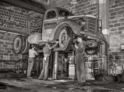 March 1943. "Baltimore, Maryland. Davidson Transfer Company trucking terminal. Lubricating a truck tractor." Acetate negative by John Vachon, Office of War Information. View full size.
Where To Put The OilI am guessing this is a diagram of all the places to grease and oil?
Reminds Me of Big Joe&#039;s Trailer TruckOne of my son's favorites.
https://www.bing.com/images/search?view=detailV2&amp;ccid=K3G056%2Br&amp;id=2A1F...
Jughead hatThe hat with the buttons immediately made me think of the Archie Comics character Jughead. Then I saw the guy on the right has a Jughead-ish crown, too.
A little internet sleuthing taught me that the Whoopee cap "was often made from a man's felt fedora hat with the brim trimmed with a scalloped cut and turned up. In the 1920s and 1930s, such caps usually indicated the wearer was a mechanic."
The Jughead / Goober capMust have been at peak popularity. 
JugheadgearMy uncle called his a "greasecap."  For obvious reasons.
GreasersFrom the looks of those treads and that floor, you might wanna take it out for a drive on a dusty road first. 
Davidson MovingI remember them well. They moved my family from Baltimore to Denver in 1967.
Keep the shiny side upand the greasy side down. Farewell message between truckers on the CB in the seventies.
&quot;S&quot; Ration Sticker?What appears to be an "S" sticker is in the place where gas ration stickers were customarily placed on windshields during the war years. I have found explanations for the A, B, C, M, T, and the much-coveted X stickers. But I can't find any explanation for the S sticker. It seems like the truck would be eligible for the "T" sticker which would give the driver whatever gas was needed for their job. Anyone have any information?
[Click here. - Dave]
Thanks! -A/O
(The Gallery, Baltimore, Cars, Trucks, Buses, Gas Stations, John Vachon)