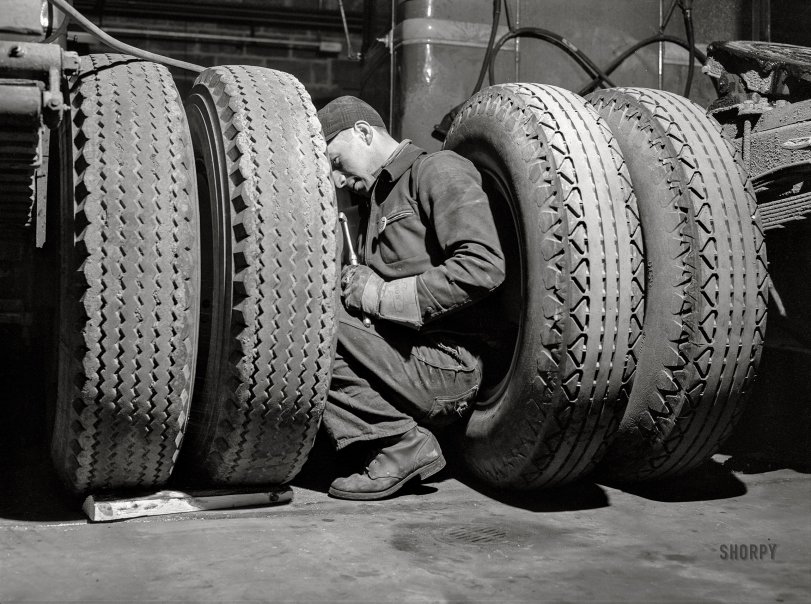 March 1943. "Baltimore, Maryland. Davidson Transfer Company trucking terminal. Checking the tires on truck tractors." Photo by John Vachon, Office of War Information. View full size.
