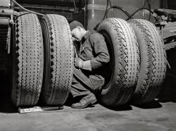 March 1943. "Baltimore, Maryland. Davidson Transfer Company trucking terminal. Checking the tires on truck tractors." Photo by John Vachon, Office of War Information. View full size.
He must be working too hard. He looks tired. 
Thank you ladies and gentlemen, I'll be here all week. 
(The Gallery, Baltimore, Cars, Trucks, Buses, John Vachon)