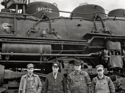 March 1943. "Wellington, Kansas. An Atchison, Topeka and Santa Fe Railroad crew posing in front of their engine before pulling out of Wellington for Waynoka, Oklahoma. Left to right: D.C. Quivey, head brakeman; D.B. Wallingford, conductor; B.F. Hale, engineer; and fireman Walker." Acetate negative by Jack Delano for the Office of War Information. View full size.