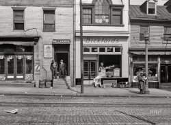 March 1943. "Baltimore, Maryland. A street scene." Billiards, Bickford's and the New Coney Island Cafe. Acetate negative by John Vachon for the Office of War Information. View full size.