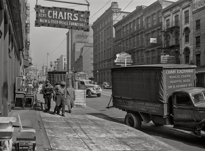 March 1943. "Baltimore, Maryland. Trucks in the wholesale district." At the Chair Exchange on South Howard Street. Photo by John Vachon for the Office of War Information. View full size.