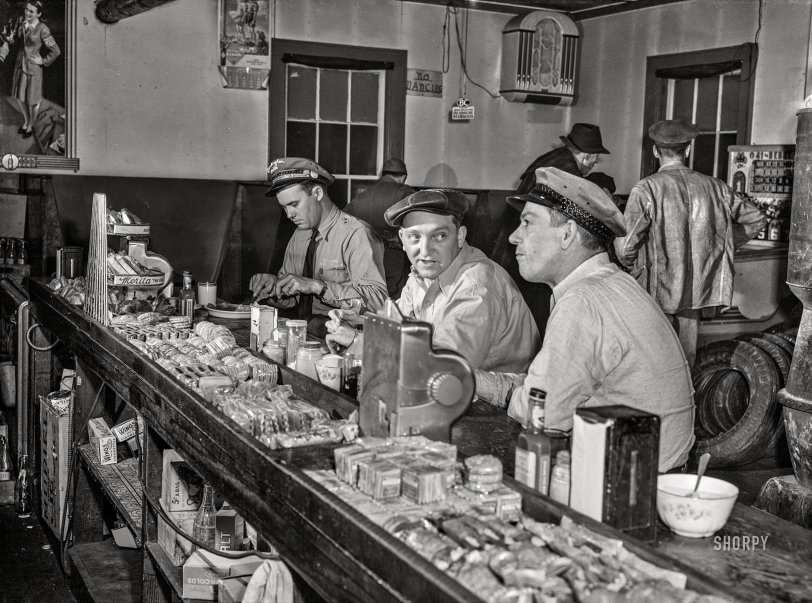 March 1943. "Sam Bens and Noah Booher, drivers for Associated Transport Company, having dinner with a textile mill truck driver at a highway stop along U.S. Route 11 near Wytheville, Virginia." Acetate negative by John Vachon for the Office of War Information. View full size.
