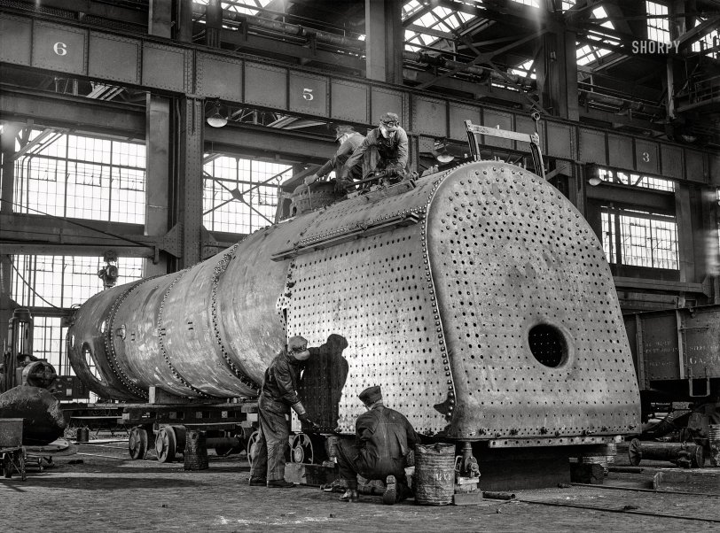 March 1943. "Albuquerque, New Mexico. Men working on the firebox of an engine in the Atchison, Topeka and Santa Fe Railroad locomotive shops." Medium format acetate negative by Jack Delano for the Office of War Information. View full size.