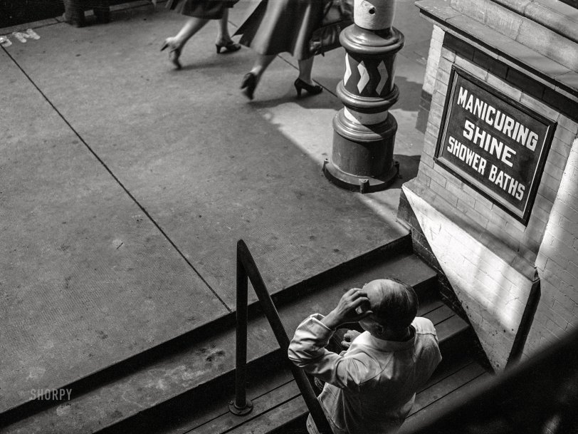 March 1943. "Lynchburg, Virginia. A barber in front of his shop." Medium format acetate negative by John Vachon for the Office of War Information. View full size.