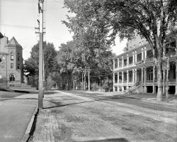 Circa 1904. "State Street and Pavilion Hotel, Montpelier, Vermont." 8x10 inch dry plate glass negative, Detroit Publishing Company. View full size.
Same as it ever was.For the most part, on the corner of Taylor street:
View Larger Map
Is that a water tank wagon?On the right side of the road, in the distance, is what appears to be a water dispersing wagon, perhaps spraying the road to keep down the dust? If so, I wonder how long that would last before the water evaporated away.
Oil works so much better, as the American military realized when treating dirt roads in the South Pacific, prompting some Japanese officer to comment that he knew the war was lost when he saw the Americans using that precious commodity for such a mundane task.
Or, is it something entirely different? 
[Note the spray. -tterrace]
Bingo! What do you use to create that further enlargement?
[The full-size 168 Mb scan from the LOC, also enlarging that to 150%. -tterrace]
(The Gallery, DPC)