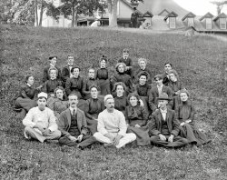 Circa 1900. "Group at the Balsams. Dixville Notch, White Mountains, New Hampshire." The hotel staff, all of whom are upstairs these days. View full size.
Axle GreaseThe stylish man's pomade.
Top of the hillThose three need a backstory.
Scary in backThe people in the front row look like regular folks, just like anyone you might see on the street today.  But as you go back in the group, many of the people have the dead-eyed stare of characters in old horror movies.  I'm sleeping with the light on tonight.
The Plot ThickensThe three on the hill in the rear row were known, left to right, by their fellow employees as Light-In-The-Head Lettie, Smackback Jack, and Anxious Annie.
Lettie fell off the train on the spur in front of the hotel one afternoon and hit her head, although some thought Jack pushed her.  In any case, that was the day they both earned their nicknames.  It was further rumored that Annie did indeed witness the incident from one of the attic dormers, and she knew that Lettie had just the day before given Jack his walking papers.  Poor Annie at first became nervous whenever jack came physically close to her, but then worried continuously, eventually becoming addicted to Paregoric as a calmative.
All women will wear 18 yards of material in their dresses and men will part their hair in the middle for the staff photo.
(The Gallery, DPC)