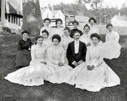 Poland Spring, Maine, circa 1900. "At the Mansion House -- hotel staff." 8x10 inch dry plate glass negative, Detroit Publishing Company. View full size.
Keep a straight face, he&#039;s the bossThe diversion may be one of the young Ricker family tripping over their billfold, a rich kid no doubt, (unlike tterrace!)
more on The Mansion at Poland Spring here.
One Lucky GentlemanI wonder what the diversion is to their right. Looks like it could be amusing. This type of photograph is to me most fascinating because of the variety of faces and expressions.
Grass stainsOn those white dresses: must have been a constant problem. And those high collars in the summer, along with the long sleeves, must have made for plenty of sweat. (Although ladies didn't sweat then; they "glowed".) I wonder what they're looking at to their right, just outside of camera range. 
Off to their rightGiven the setting, I conjecture that upon the photographer's "Watch the birdie!" some looked at the wrong one.
A Little Less Starch Please!That guy in the middle looks like both he and his clothes got the full starch treatment.
[That may be a celluloid collar and shirt front or "dickey." - tterrace]
Uh Oh !It looks like two of these women are wearing the same dress. That must have been awkward.
A William Dean Howells fanI must thank you for these photos. Howells wrote a number of books set in the genteel milieus of the large resort hotels in New England, which flourished so magnificently at the turn of the 20th Century. These portraits give actual faces and costumes to the staff at those proud palaces of leisure and relaxation.
(The Gallery, DPC)